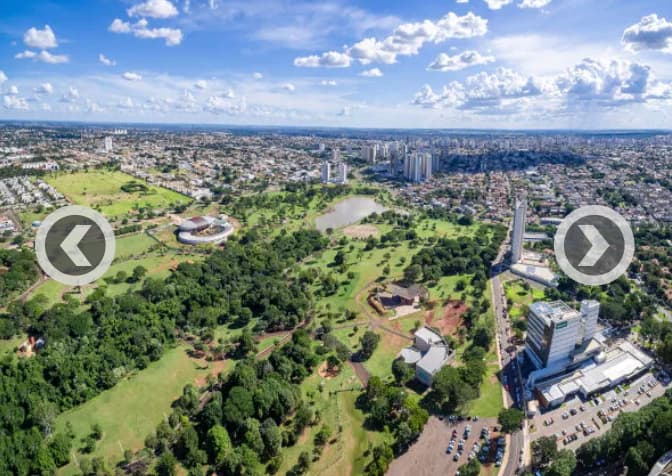 Vista aérea panorâmica da cidade com ampla área verde e parque urbano