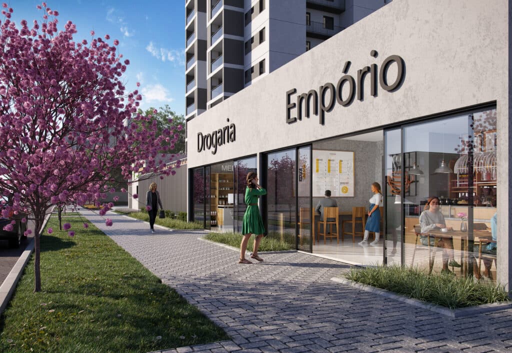 Fachada externa de comércio no térreo com calçada pavimentada e árvore com flores cor-de-rosa
